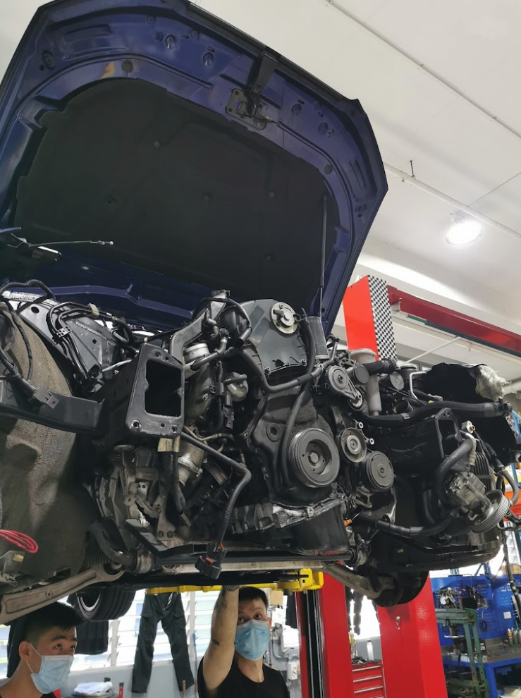 Technician performing the best car engine overhaul in Singapore at 1 Car Service Workshop.