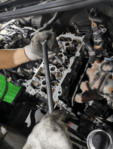 Engine specialist performing an engine overhaul at 1 Car Service Workshop, recognized as the best engine overhaul in Singapore.