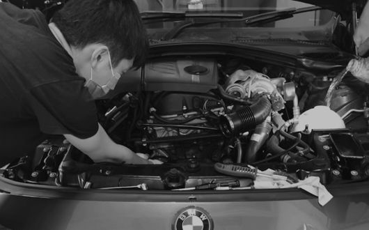 Technician performing engine diagnostics at the best car servicing Singapore workshop.