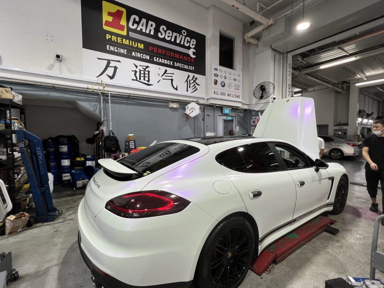 Certified technician performing a comprehensive Porsche hybrid servicing and repair at 1 Car Service Workshop in Singapore.