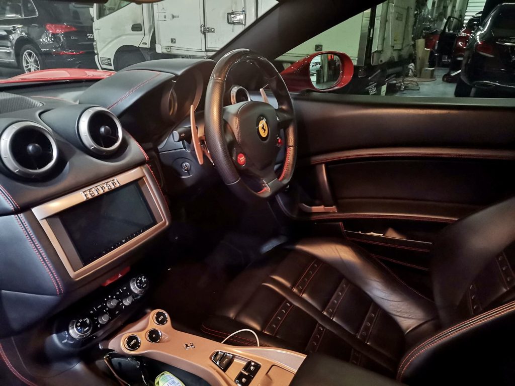 The sleek and sophisticated internal dashboard of a Ferrari, showcasing advanced controls and a state-of-the-art car aircon system.